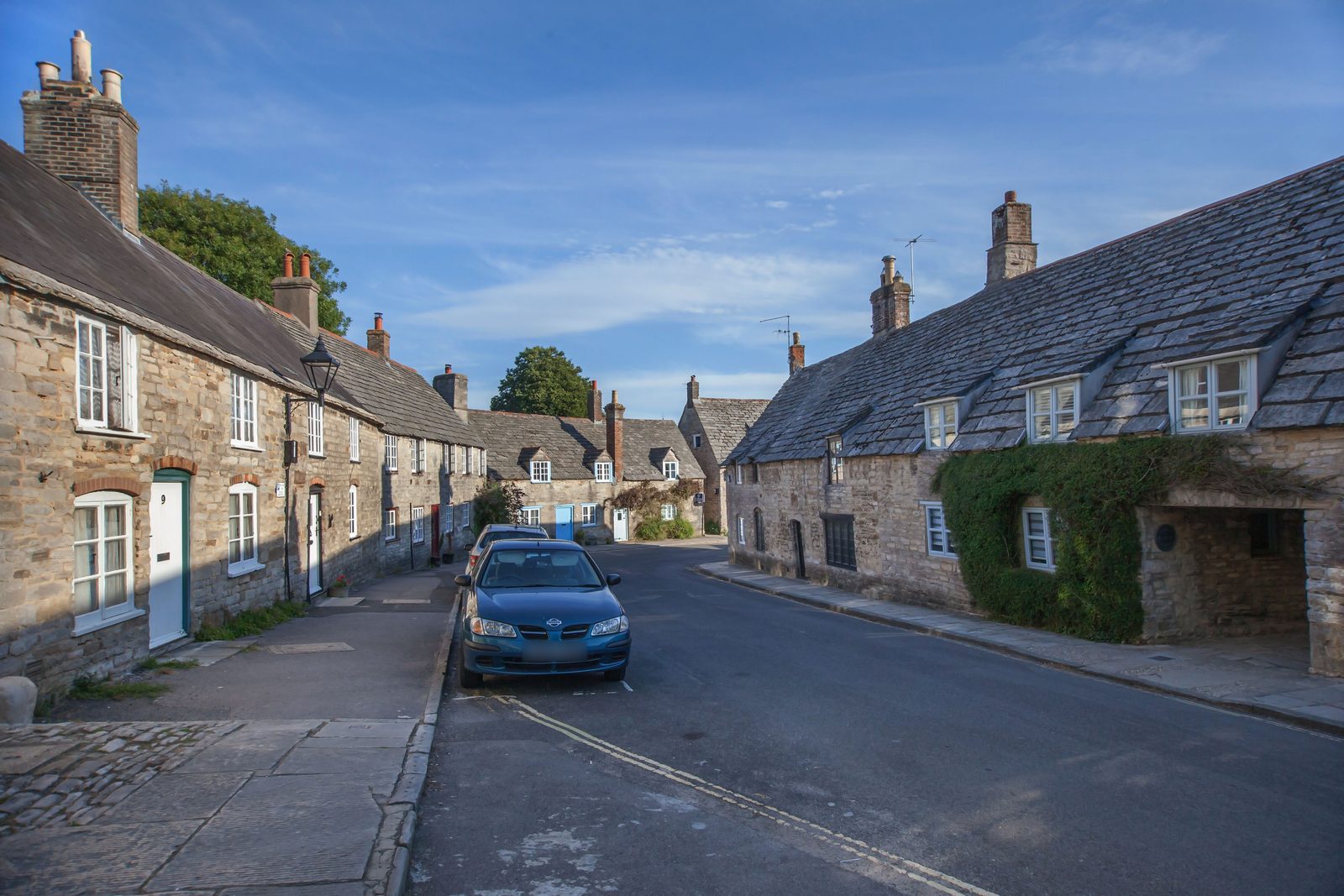 Stone cottages along a quiet village street in Dorset.