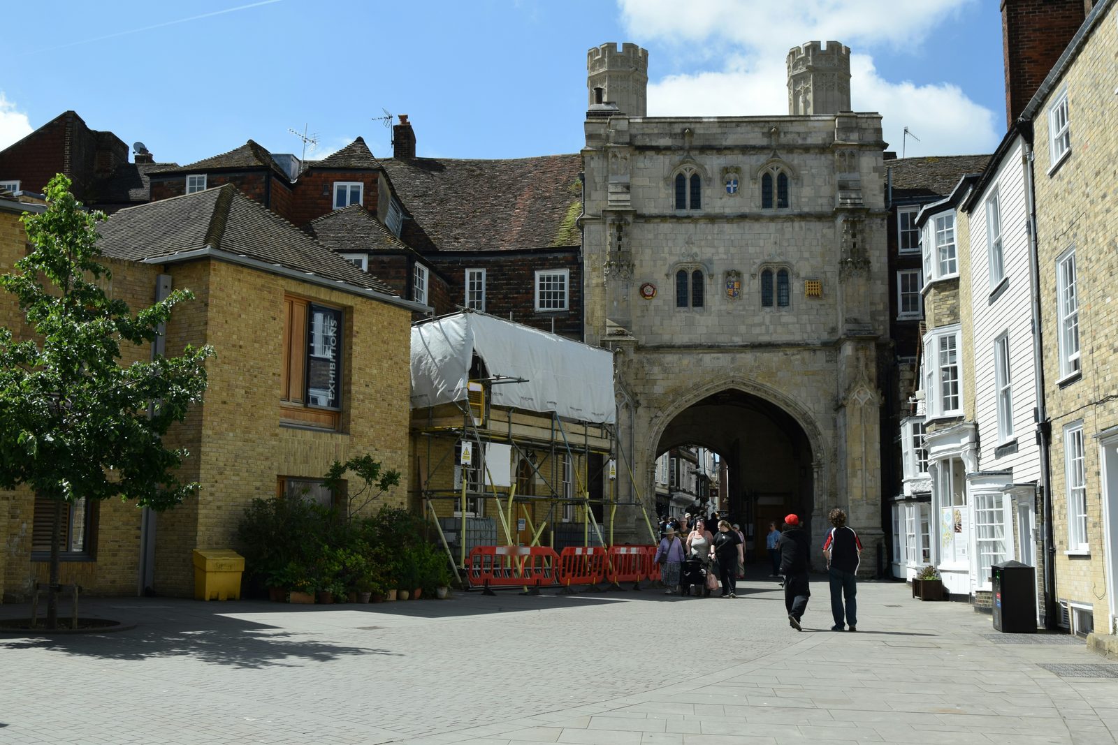 Old houses around a stone gatehouse in Kent.
