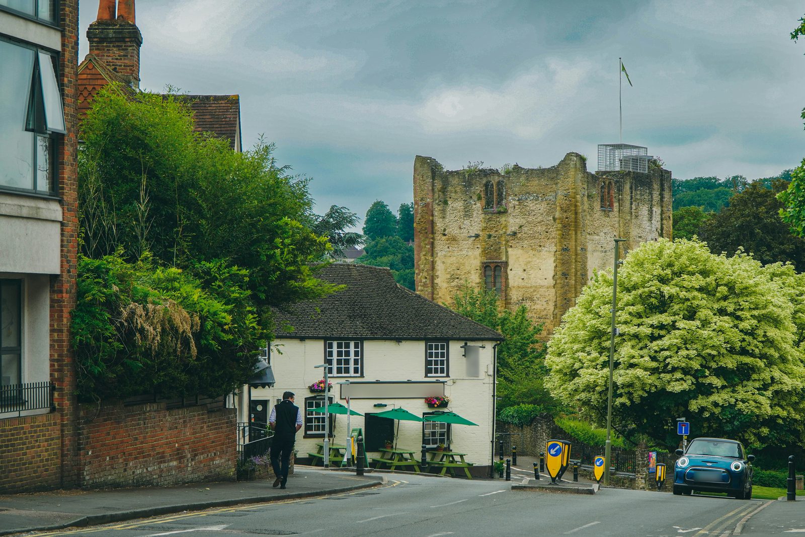 Old buildings and a castle keep at the top of a Surrey street.